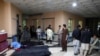 Afghan men look for their relatives as body bags are laid out at a hospital, following a suicide bombing in Kabul, Afghanistan, Oct. 24, 2020.
