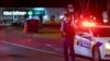 Police stand outside the site of a knife attack at a supermarket in Auckland, New Zealand, Sept. 3, 2021.