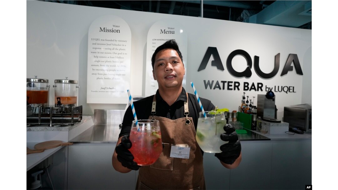 JC, mixologist, presents two types of gourmet water cocktails at the AQUA Water Bar by LUQEL in Dubai, United Arab Emirates on July 11, 2023. (AP Photo/Kamran Jebreili)