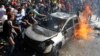 Civil defence members and civilians put out a fire at the site of an explosion in the southern suburbs of Beirut, Feb. 19, 2014.