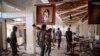 FILE - Fano fighters walk through a ransacked building in the Amhara region of Ethiopia, Dec. 7, 2021. Violence erupted March 1, 2024, between Ethiopian government forces and members of the militia.