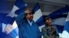 FILE - Nicaraguan President Daniel Ortega and Vice President Rosario Murillo gesture during a march called 'We walk for peace and life. Justice' in Managua, Nicaragua, Sept. 5, 2018. 