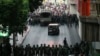 Protesters, background, confront Thai soldiers blocking the road during an anti-coup demonstration at the Victory Monument in Bangkok, Thailand, May 26, 2014. 