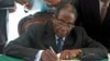 Zimbabwe President Robert Mugabe signs Zimbabwe's new constitution into law in Harare, May 22, 2013.