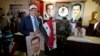 A man holds a portrait of President Bashar al-Assad and a national flag at a polling station in Damascus, June 3, 2014. 