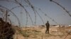 A member of Palestinian security forces loyal to Hamas patrols at the border between Egypt and the Gaza Strip, March 4, 2014. 