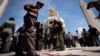 Thai police investigate following an overnight shooting attack at Democracy Monument in Bangkok, Thailand, Thursday, May 15, 2014.