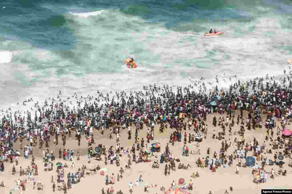 Thousands of New Year&#39;s day revelers and holidaymakers gather on the North Pier Beach during New Year festivities in Durban, South Africa, Jan. 1, 2022, after the government lifted a COVID-19 restriction.