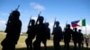 FILE - Soldiers march at Guiuan airport to take part in the welcoming ceremony for visiting French President Francois Hollande in Guiuan, Samar, a town that was devastated by Typhoon Haiyan in central Philippines, February 27, 2015.
