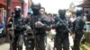 Polisi anti-teror membawa barang bukti dari rumah seorang pria yang diduga terlibat dalam aktivitas terkait ISIS di Tangerang Selatan, Banten (22/3). (Reuters/Antara/Muhammad Iqbal)
