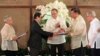 Philippine President Benigno Aquino (C) applauds as Moro Islamic Liberation Front (MILF) chief negotiator Mohagher Iqbal (2nd L) shakes hands with Senate President Franklin Drilon (2nd R) during the turnover ceremony of the draft Bangsamoro Basic Law (BBL