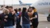 Relatives of Ukrainian prisoners freed by Russia greet them upon their arrival at Boryspil airport, outside Kyiv, Ukraine, Sept. 7, 2019. 