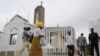 Worshipers arrive at Holy Trinity Catholic Church in Nigeria's capital, Abuja, June 24, 2012. 