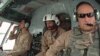 FILE - U.S. Air Force Major Micah West helps to train Afghan pilots in the southern province of Kandahar in August 2010. 