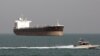 FILE - An Iranian Revolutionary Guard speedboat passes near an oil tanker, July 2, 2012. A collision late Saturday off the eastern coast of China left 30 Iranians missing.