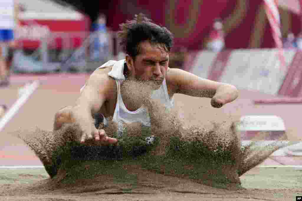 Afghanistan&#39;s Hossain Rasouli competes in the men&#39;s T47 long jump during the 2020 Paralympics at the National Stadium in Tokyo, Japan.