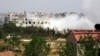 Smoke rises from a part of the Mleha town in the suburb of Damascus during the clashes between rebel fighters and forces loyal to Syria's President Bashar al-Assad, April 12, 2014.