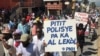 Haiti police protester holds poster that reads: “policemen’s children can’t go to school”, in Port au Prince, Haiti, Oct 27, 2019. (Matiado Vilme / VOA Creole) 