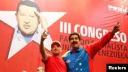 FILE - Venezuela's President Nicolas Maduro, right, embraces retired General Hugo Carvajal as they attend the Socialist party congress in Caracas, July 27, 2014. 