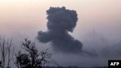 This picture taken from southern Israel near the border with the Gaza Strip shows smoke billowing after an Israeli strike on north Gaza on November 23, 2023, amid ongoing battles between Israel and the Palestinian Hamas movement. (Photo by Menahem KAHANA 