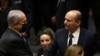 Israel's new prime minister, Naftali Bennett, shakes hands with outgoing prime minister, Benjamin Netanyahu, during a Knesset session in Jerusalem, June 13, 2021.