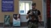An armed serviceman stands guard at a cordon near a cafe, where leader of the separatist self-proclaimed Donetsk People's Republic Alexander Zakharchenko was killed, in Donetsk, Ukraine, Aug. 31, 2018.