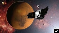 FILE - In this artist concept provided by NASA, the MAVEN spacecraft approaches Mars on a mission to study its upper atmosphere. NASA said Thursday that the satellite's route was tweaked to avoid a collision with one of the planet's two small moons.