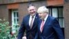 Britain's Prime Minister Boris Johnson, right, welcomes U.S. Secretary of State Mike Pompeo to Downing Street, London, ahead of a private meeting, July 21, 2020. 