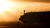 A ground crewman stands in front of a South Korean P3 Orion after it returned from the search for missing Malaysia Airlines Flight MH370 in Perth, Australia, Sunday, March 30, 2014.