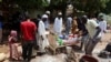 FILE - People wait to get food distributed by volunteers in Omdurman, Sudan, on Sept. 3, 2023.