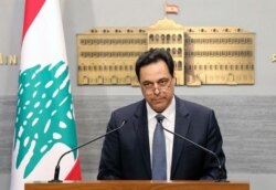 FILE - In this photo released by the Lebanese Government, Lebanese Prime Minister Hassan Diab, gives a speech at the Government House in Beirut, Lebanon, March 7, 2020.
